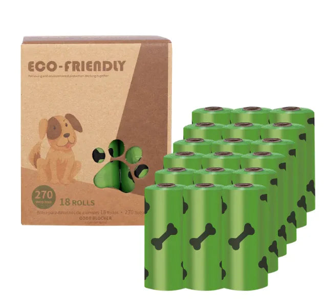 Green rolls of dog waste bags next to a cardboard box labelled 'Eco-Friendly' on a white background