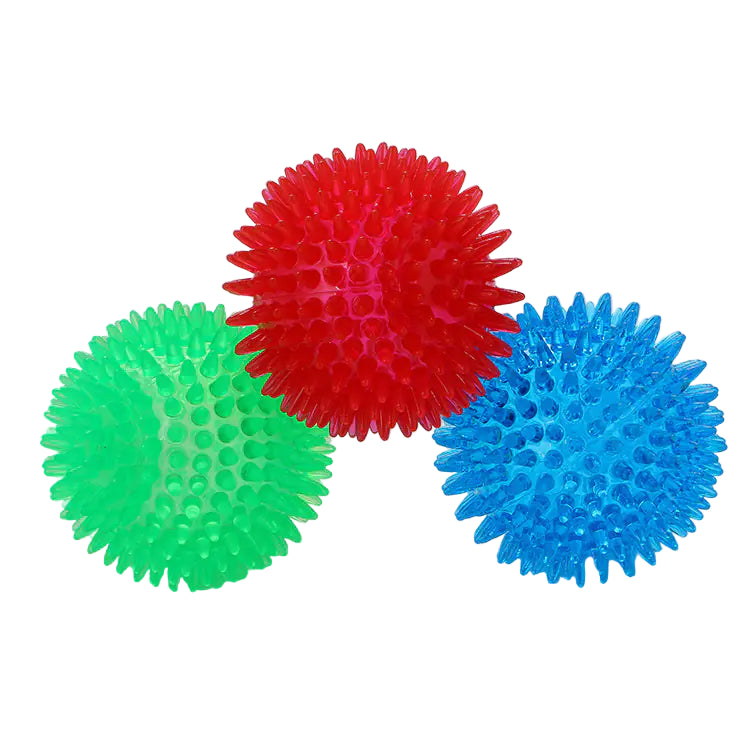 Three textured spiky balls in red, green, and blue on a white background.